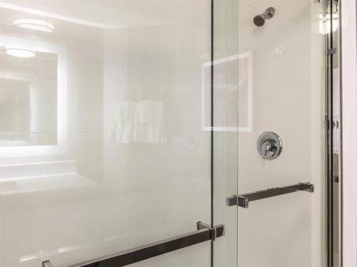 a shower stall with a glass door in a bathroom at La Quinta by Wyndham Austin Airport in Austin