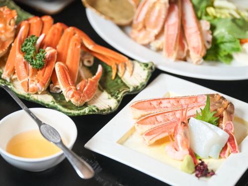 a group of plates of food on a table at Sinonomesou Kinosaki Onsen in Toyooka