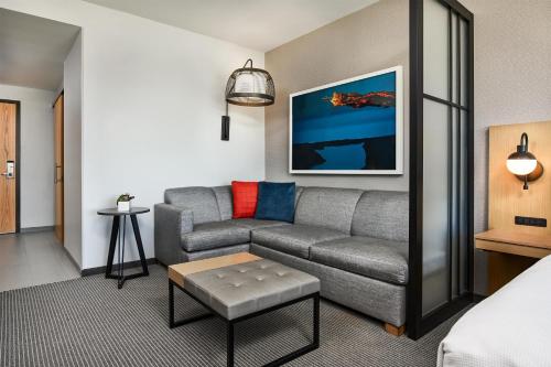 a living room with a couch and a table at Hyatt Place Pena Station/Denver Airport in Denver