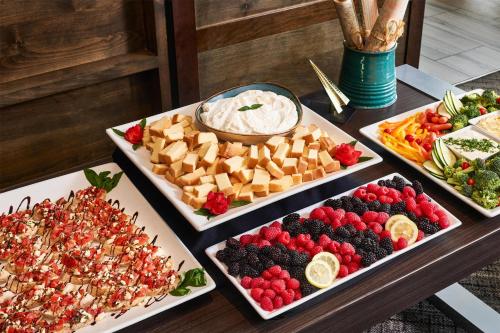 a table with three trays of different types of food at Hyatt Place Pena Station/Denver Airport in Denver