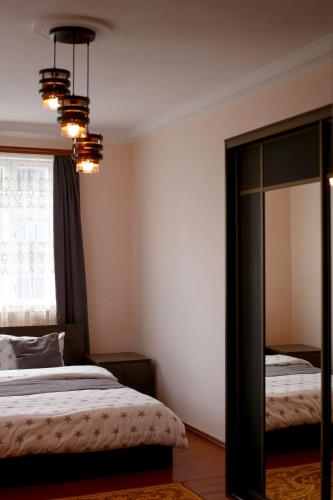 a bedroom with a bed and a mirror and a window at MARY in Stepʼanavan