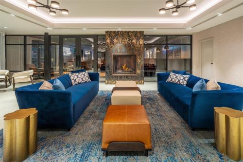 a lobby with blue couches and a fireplace at DoubleTree by Hilton Sioux City in Sioux City