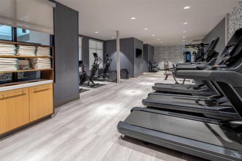 a fitness room with treadmills and exercise bikes at DoubleTree by Hilton Sioux City in Sioux City