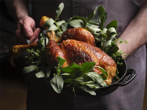 a person holding a bowl of food with greens at NoMad London in London
