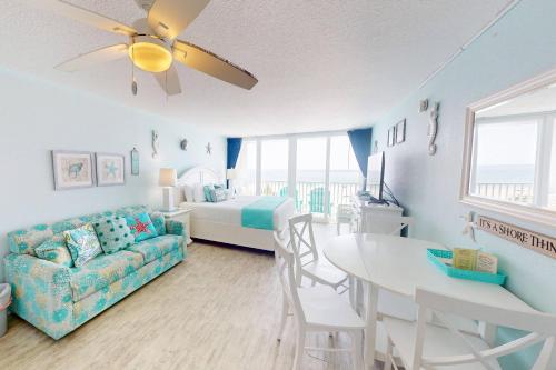 a living room with a couch and a bed and a table at 318 - Island Inn in St. Pete Beach