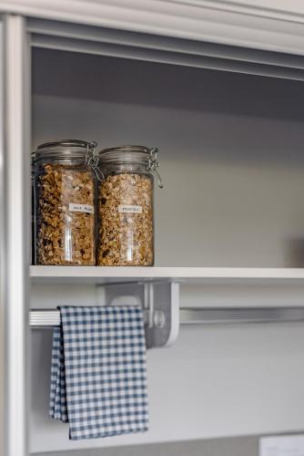 two jars of food sitting on a shelf in a refrigerator at Mala Retreat, Shiraz Suite 5 Star Immaculate and Comfortable in East Maitland