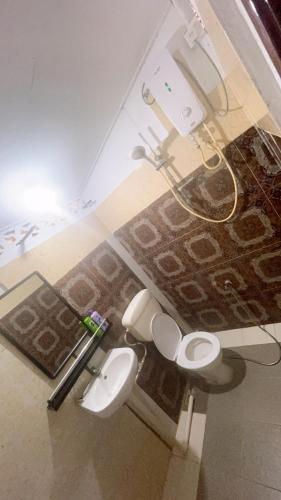 a bathroom with two toilets in a room at Simple2 Guesthouse in Pantai Cenang