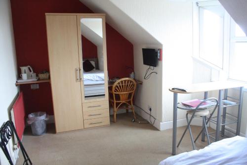 a bedroom with a door leading into a room with a bed at Harbour House Bed & Breakfast - Wick in Wick