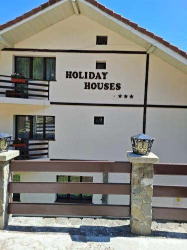 a building with a sign that reads holiday houses at Holiday Houses in Sinaia