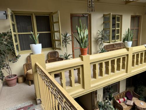 a balcony with potted plants on a house at The Melo pomelo courtyard. ( Right in between Thamel and basantapur durbar square) in Kathmandu