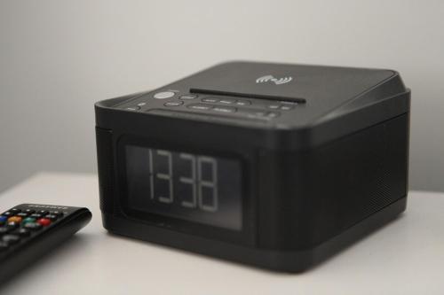 a black clock sitting next to a remote control at Mala Retreat Chardonnay Studio Immaculate and Comfortable in East Maitland