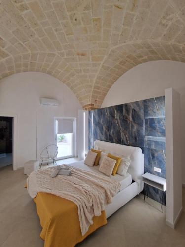 a bedroom with a large bed with a stone ceiling at Home Belvedere in Brindisi