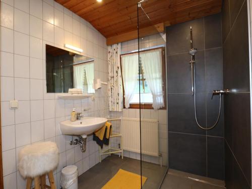 a bathroom with a sink and a shower at Apartment in See near Bathing Lake in See