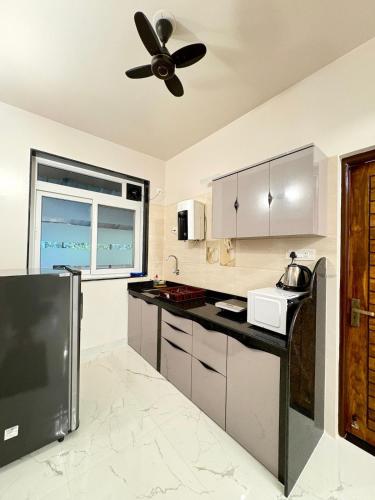 a kitchen with a ceiling fan and a counter at Cinnamon Stays Benaulim in Benaulim
