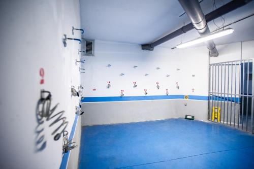 a gym with a blue floor in a room at AZZ Asturias LangreHotel & Spa in Langreo