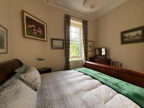 a bedroom with a bed and a window at Shannon River House & Gardens in Limerick