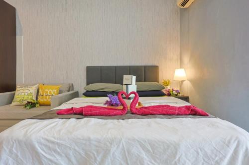 a bed with two pink flamingos on it at 5mins to Sunway Pyramid #Subang SS15 Cozy Studio Menara Rajawali in Subang Jaya