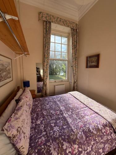a bedroom with a large bed and a window at Shannon River House & Gardens in Limerick