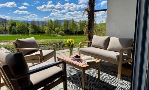 a patio with two chairs and a table with a view at Zaczarowane Wzgórze - Domek w Beskidach in Czaniec