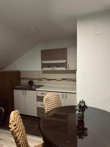 a kitchen with a table and chairs in a room at Privatni smestaj - Grujic in Bujanovac