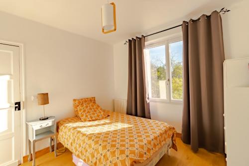 a bedroom with a bed and a window at Maison de vacances in Sarlat-la-Canéda