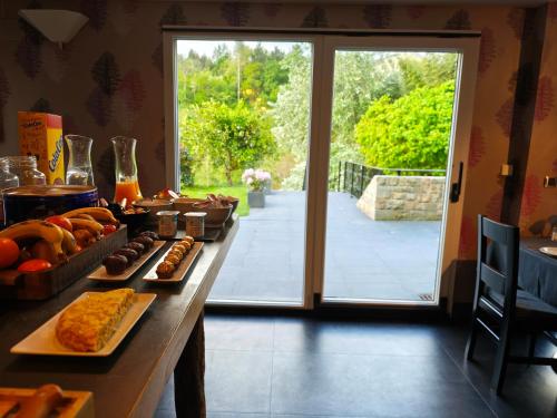 a table with food on it in front of a door at Hotel Aldori Landetxea - Reserva de la Biosfera Urdaibai - Adults Only in Muxika