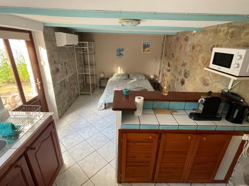 une cuisine avec un lit dans une chambre dans l'établissement Villa Jean proche port et haute ville, à Porto-Vecchio