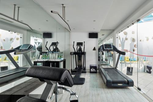 a gym with treadmills and elliptical machines at Arte & Mare Elia Luxury Suites and Villas in Elia Beach
