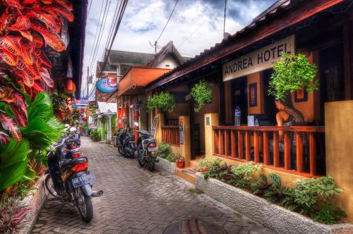 a street with motorcycles parked in front of a building at Andrea Hotel in Yogyakarta