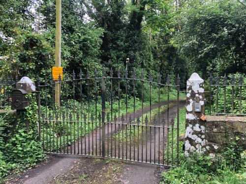 an iron gate with a path through a garden at Shannon River House & Gardens in Limerick