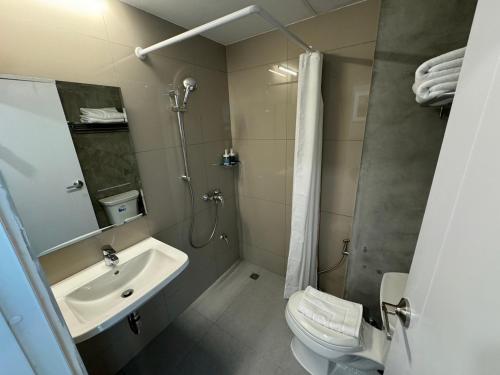 a bathroom with a sink and a shower and a toilet at Rimm49 Bangkok in Bangkok