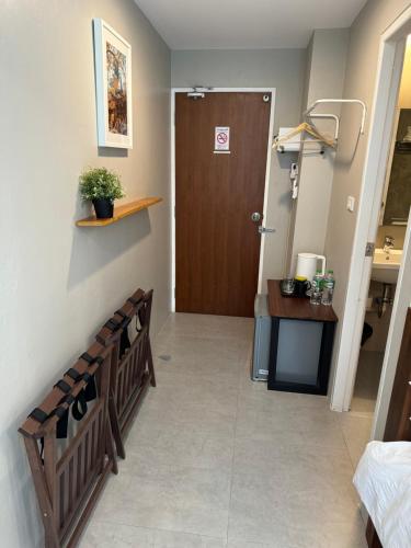 a hospital hallway with a door and a table and a desk at Rimm49 Bangkok in Bangkok