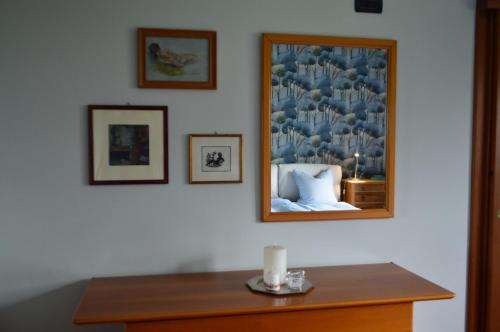 a room with a table with a picture on the wall at Villa Collebelvedere - Near Rome with Home Restaurant in Fara in Sabina
