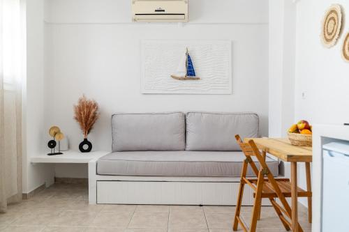 a living room with a couch and a table at Trouhalos Apartment in Livadion