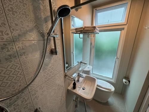 a bathroom with a shower and a sink and a toilet at Rimm49 Bangkok in Bangkok