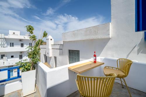 a balcony with a table and chairs on a building at Trouhalos Apartment in Livadion