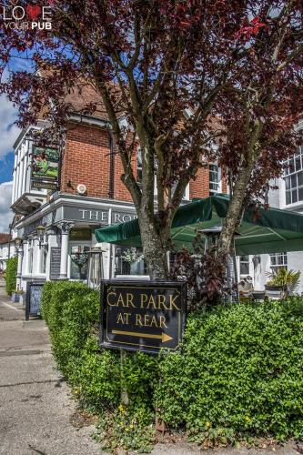 a car park sign in front of a tree at Robin Hood Inn in Rowlands Castle