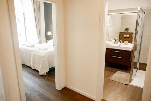 a bathroom with a bed and a sink and a mirror at Luxury Modern Designed Oldtown Apartment in Prague