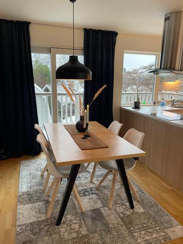 a dining room with a wooden table and chairs at Exclusive apartment with great views close to city center in Svolvær