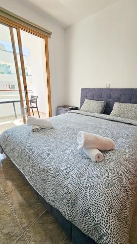 a bedroom with a bed with towels on it at Central City Rooms in Larnaca