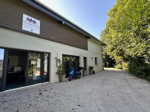 a building with a motorcycle parked outside of it at LES ANTHOCYANES in Champagny