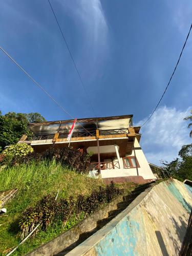 a house that is on top of a hill at Evergreen Lodge in Padang