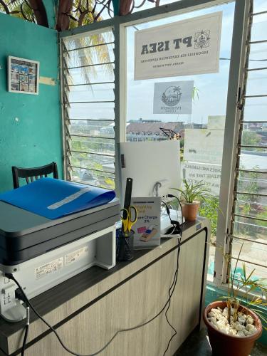a room with a bed on top of a counter at Evergreen Lodge in Padang