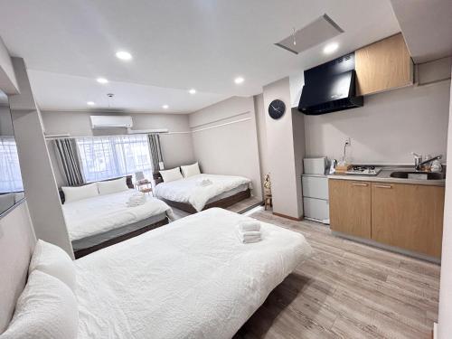 a small room with two beds and a kitchen at Y-Shinjuku City, Okubo 3F-SJ0069 in Tokyo