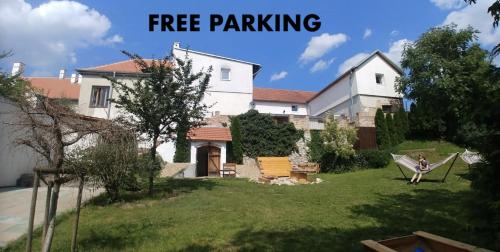 a person sitting in a hammock in a yard at Slavia penzion in Mikulov
