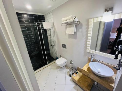 a bathroom with a toilet and a sink and a shower at City Center Hotel Taksim İstanbul in Istanbul