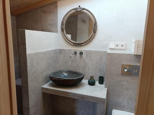 a bathroom with a sink and a mirror at El Freixe de l'Ylla in Els Hostalets