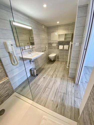a bathroom with a sink and a toilet at Hotel L'ondine in Algajola