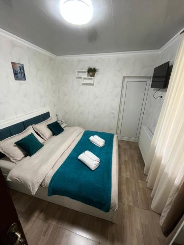 a bedroom with a bed with two towels on it at garden and panorama in Mtskheta
