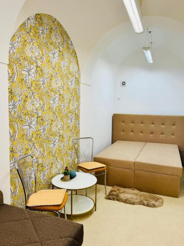 una habitación con una cama, una mesa y sillas en Apartmán HUGO, en Jaroměř